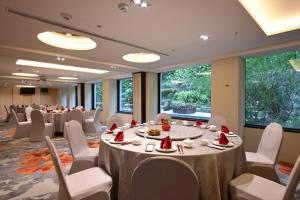 a conference room with tables and chairs with food on them at The Gaia Hotel - Taipei in Taipei
