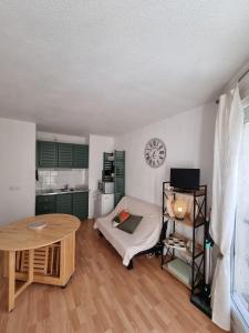 a living room with a table and a kitchen at Studio Barèges in Barèges