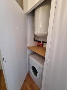 a small kitchen with a washing machine and a microwave at Studio Barèges in Barèges
