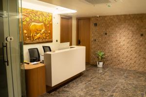an office with a reception desk and a painting on the wall at AAA URBAN STAY-Madhapur in Hyderabad