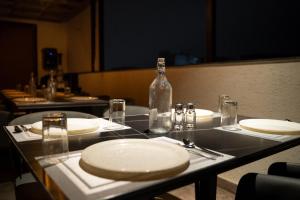a table with plates and a bottle on top of it at AAA URBAN STAY-Madhapur in Hyderabad