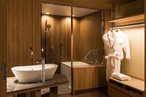a bathroom with a sink and a toilet and a tub at The Prince Park Tower Tokyo - Preferred Hotels & Resorts, LVX Collection in Tokyo