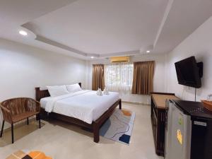 a bedroom with a bed and a television in it at Hello Jomtien in Jomtien Beach
