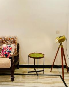 a lamp and a table and a chair in a room at Sowkya Stays, Kakinada - Home Stay, Service Apartment, Vididhillu in Kākināda