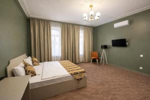 a bedroom with a bed and a television in it at The Lantern Central Hotel in Baku