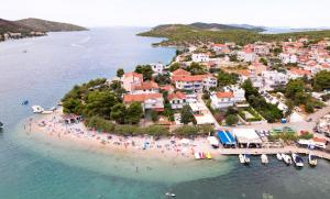 an island with a group of people on a beach at Arte Oliva in Grebaštica