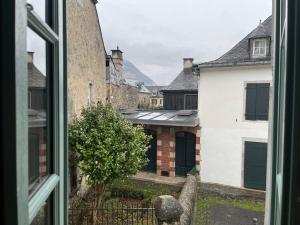 a view from a window of a street with buildings at Le Mandragot - Séjour en Aspe in Bedous