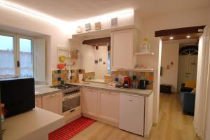a kitchen with white cabinets and a stove top oven at Lo Struzzo in Bagno di Romagna +24 photos