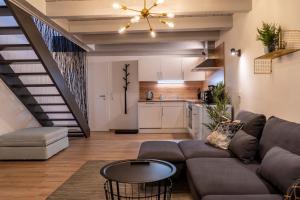 a living room with a couch and a table at Modern Western - Apartment Blue in Eging +16 photos