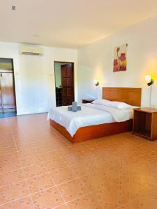 a bedroom with a large bed in a room at Landcons Hotel & Resort in Pantai Cenang