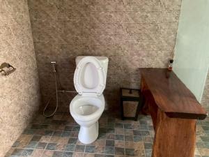 a bathroom with a toilet and a wooden counter at Baan Mada Lanta villa in Ko Lanta +4 photos