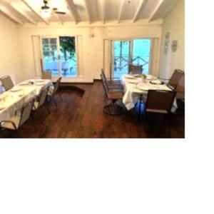 a large dining room with tables and chairs in it at EBENEZER Cottage in Discovery Bay +24 photos