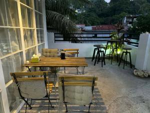 a patio with a table and chairs on a balcony at Sla guest house in Boracay