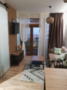 a living room with a couch and a table at Garden of Eden- MintGarden- Sveti Vlas in Sveti Vlas