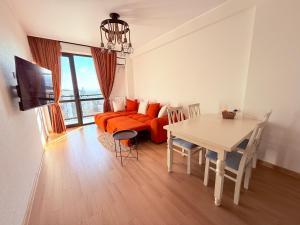 a living room with a couch and a table at Likas cozy corner in Tbilisi City