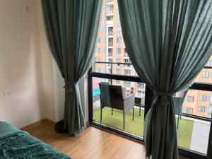 a bedroom with a window with a view of a building at Likas cozy corner in Tbilisi City
