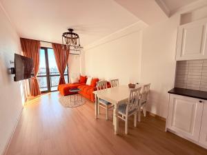 a living room with a table and a couch at Likas cozy corner in Tbilisi City
