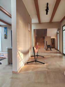 a living room with a chair and a staircase at Luxury Private Villa with Pool in The Gambia in Sambuya