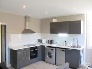 a kitchen with a washer and dryer at Les Appartements Carré d'or - Nice Centre in Nice