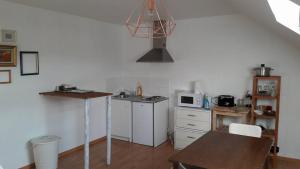 a kitchen with a table and a microwave at At the Villa in Tournai