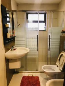 a bathroom with a sink and a toilet at Chic 2-Bedroom - Fully Furnished in Amman +7 photos