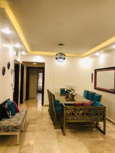 a dining room with a table and chairs at Chic 2-Bedroom - Fully Furnished in Amman