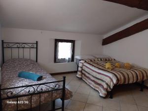 a bedroom with two beds and a window at La corte dei celti 9 in Quinzano