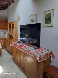 a large flat screen tv on a counter in a kitchen at La corte dei celti 9 in Quinzano +11 photos
