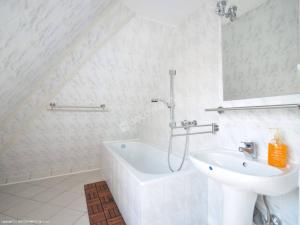 a bathroom with a sink and a tub and a toilet at Moniuszki24 in Świnoujście
