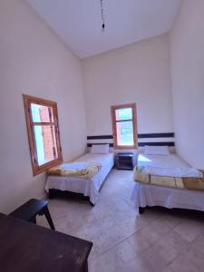 a room with two beds and two windows at Kasbah Anisi in Irhels +34 photos