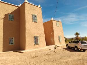 a car parked in front of a building at Kasbah Anisi in Irhels