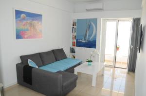 a living room with a couch and a table at Sunset by the sea 1 in Loutraki