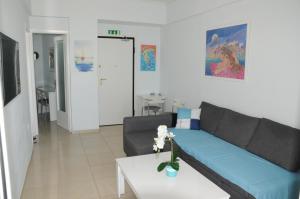 a living room with a couch and a table at Sunset by the sea 1 in Loutraki