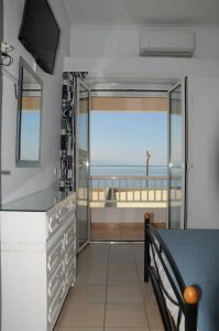 a dining room with a view of the ocean at Sunset by the sea 1 in Loutraki +22 photos
