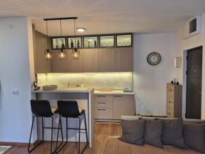 a kitchen with a couch and a table and chairs at Avram in Vrnjci