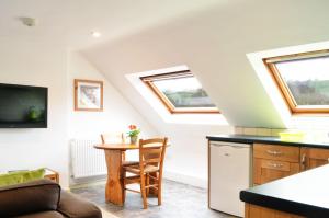 a kitchen with skylights and a table in a room at Smallicombe Farm in Colyton