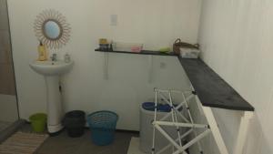 a bathroom with a sink and a mirror at Huahine's Place in HUH