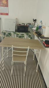a wooden table with a chair in a room at Huahine's Place in HUH