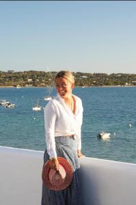 a woman standing on a boat near the water at Formentera Especial in La Savina