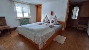 a bedroom with a large bed with pillows on it at Ferienhof Ziegler- Sonnenschein in Baiersbronn