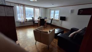 a living room with a couch and a table and chairs at Ferienhof Ziegler- Sonnenschein in Baiersbronn