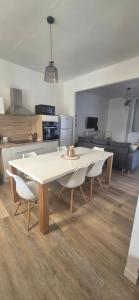 a white table and chairs in a living room at La demeure du 159 in Cognac