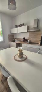 a kitchen with a white table with a bowl on it at La demeure du 159 in Cognac