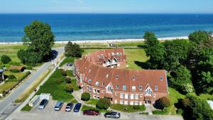 an aerial view of a large house near the ocean at Ostseeferienwohnung - Bossert in Kronsgaard
