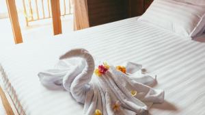 a white bed with a swan decoration on it at Lokasea Villa Bali in Pengastulan +10 photos
