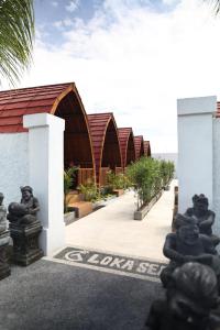 a resort with a row of buildings with trees at Lokasea Villa Bali in Pengastulan