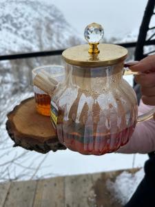a person holding a glass jar filled with honey at Green Garden in Alayaz