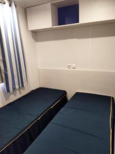 a small room with a bed and a window at chalet 2 in Saint-Christol-lès-Alès +9 photos