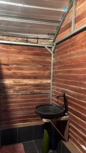 a bathroom with a sink in a wooden wall at ALAMSUKA Cikole in Tangkubanperahu +2 photos