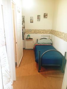 a small bedroom with a blue bed in a room at Filuvespri in Comiso +99 photos